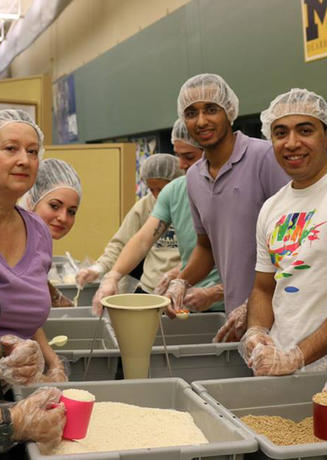 Students scooping rice for a volunteer project