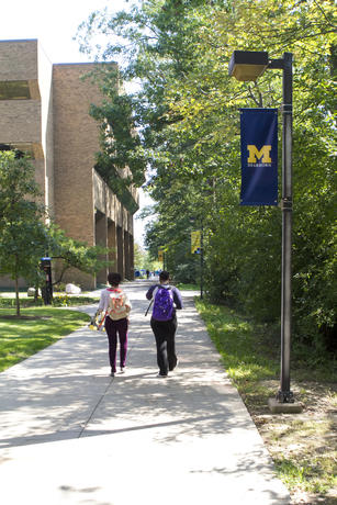 Students walking on campus near the Mardigian Library