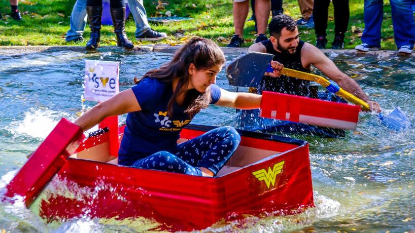 Students compete in the Cardboard Boat Races on Chancellor's Pond during Homecoming.