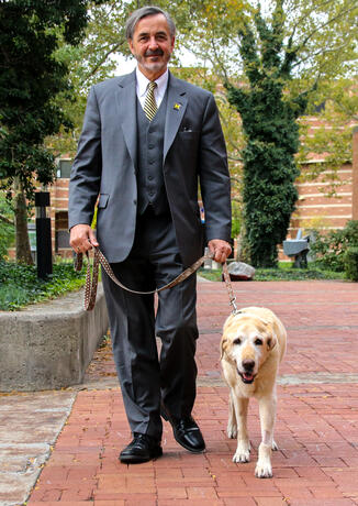 Chancellor Grasso and his very good dog outside the Administration Building.