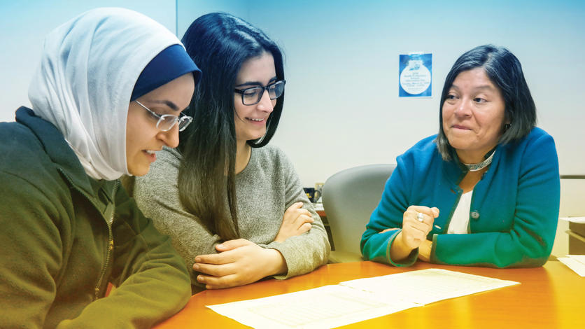 Health Professions Adviser Tahnee Prokopow (right) helps keep pre-med student Fatima Saad (center) focused with the support of mentor Mariam Ayyash. Photo by Lou Blouin.