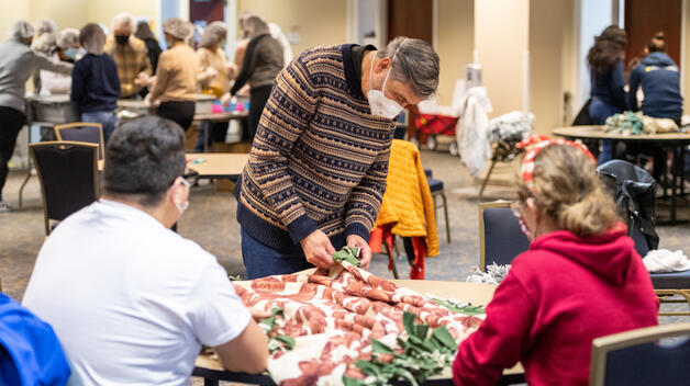 Chancellor Domenico Grasso makes fleece blankets with students at the 29th Annual MLK Day of Service.